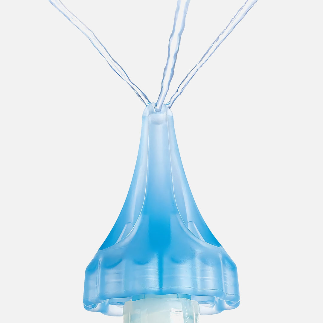 Close-up of Mack's ProRinse syringe blue tri-stream tip spraying three angled water streams