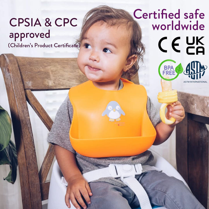 Baby wearing NatureBond orange silicone bib with wide spill pocket, BPA-free food grade material, certified safe for feeding use