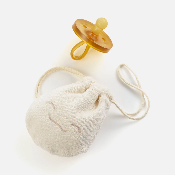 Natursutten PaciPouch organic cotton pacifier pouch shown with natural rubber pacifier, perfect for travel or on-the-go storage
