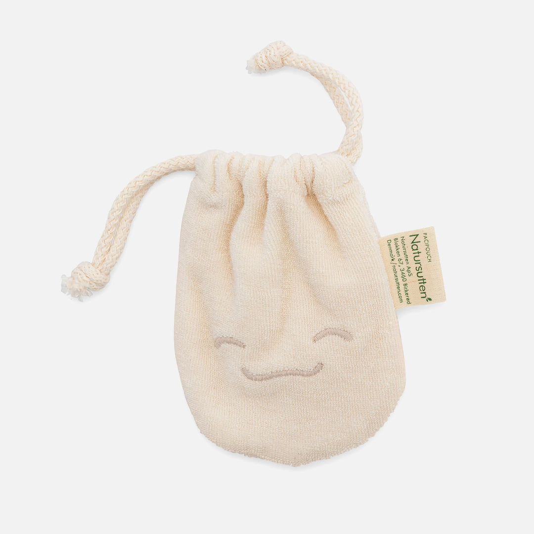 Natursutten PaciPouch organic cotton pacifier storage bag, beige color, front view with drawstring and embroidered smile.